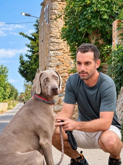 Carlos with a dog in front of a traditional Mallorcan finca
